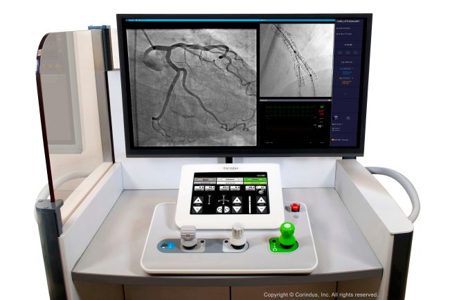 The interventional cockpit comprises a radiation shield (on the left), monitor, and control console that has three joysticks and control panel. The cockpit is mounted on a cart.