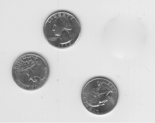 Three coins remain in the image. The area within the ROI is approximately the same color and texture as the background.